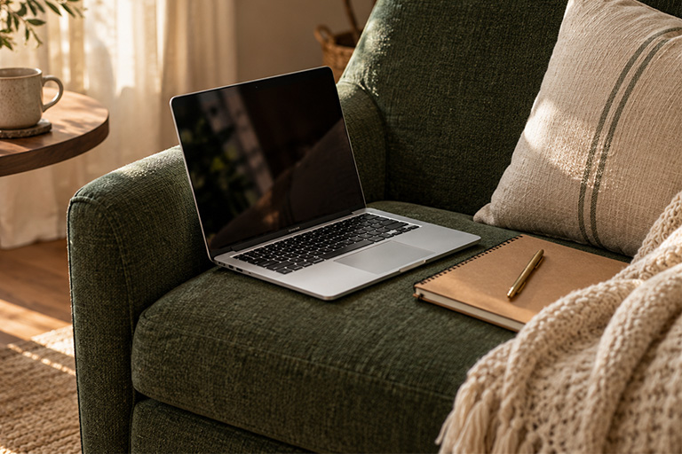 Showit template help: laptop open to a half-finished website on a green sofa